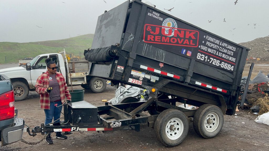 Julie and Edgar with Coast Cleaning junk removal truck